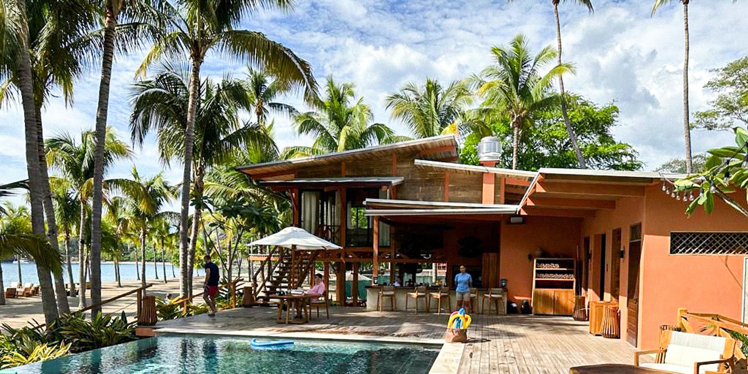 Guacamaya Beach Club pool deck surrounded by palm trees